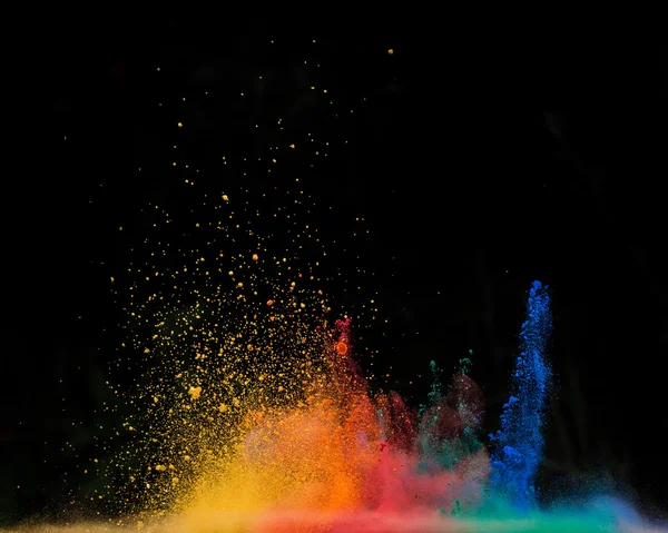 Explosion de poussière de couleur sur fond noir — Photo