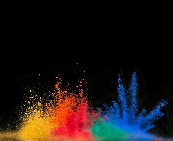 Colored dust explosion on black background — Stock Photo, Image