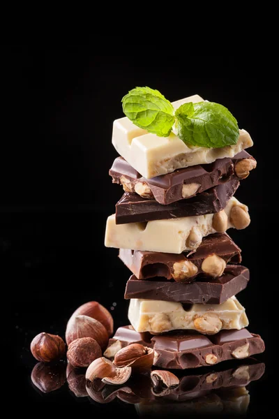Pile of hazelnut chocolate on black background — Stock Photo, Image