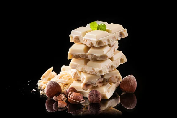 Pile of hazelnut chocolate on black background — Stock Photo, Image