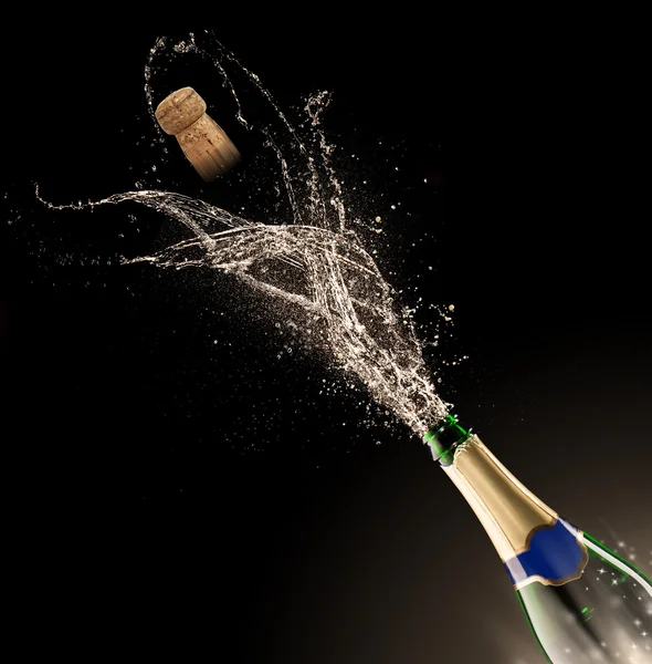 Champagne bottle with splash — Stock Photo, Image