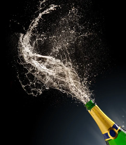 Champagne bottle with splash — Stock Photo, Image