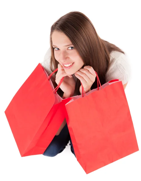 Giovane donna che trasporta borse della spesa su bianco — Foto Stock