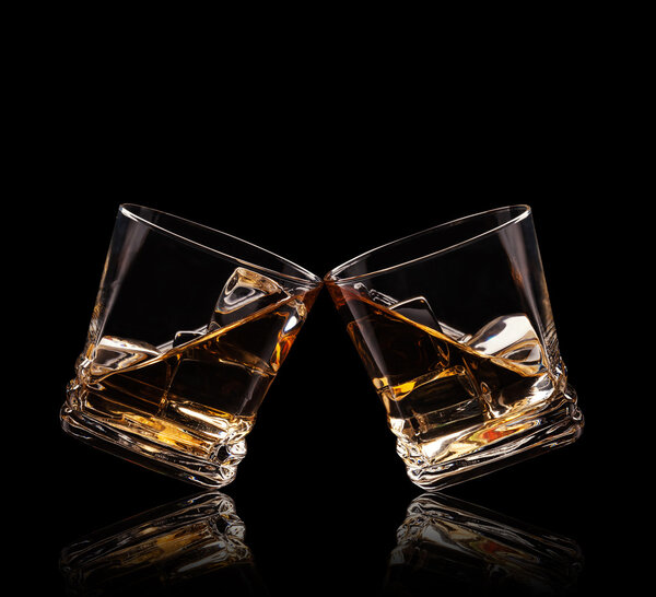 Glasses of whiskey on black background