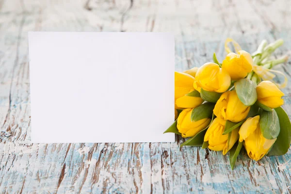 Yellow tulips on wooden planks — Stock Photo, Image