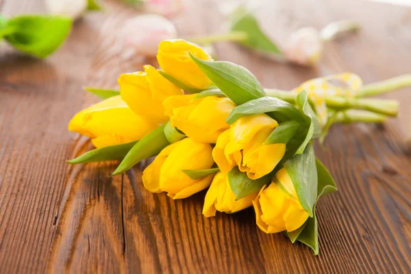 Yellow tulips on wooden planks — Stock Photo, Image