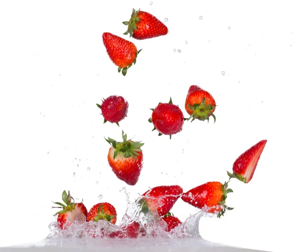 Fresas en salpicadura de agua sobre fondo blanco —  Fotos de Stock