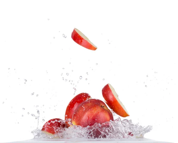 Свіже яблуко у воді бризкає на білому фоні — стокове фото