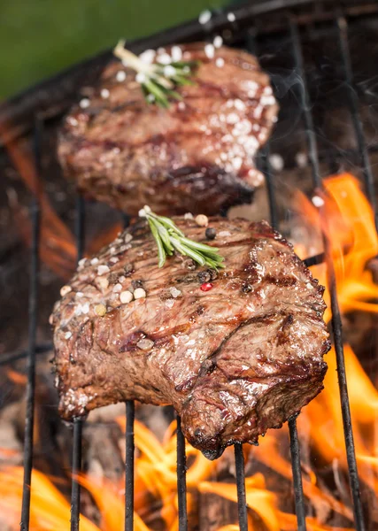 Beef steaks on grill — Stock Photo, Image