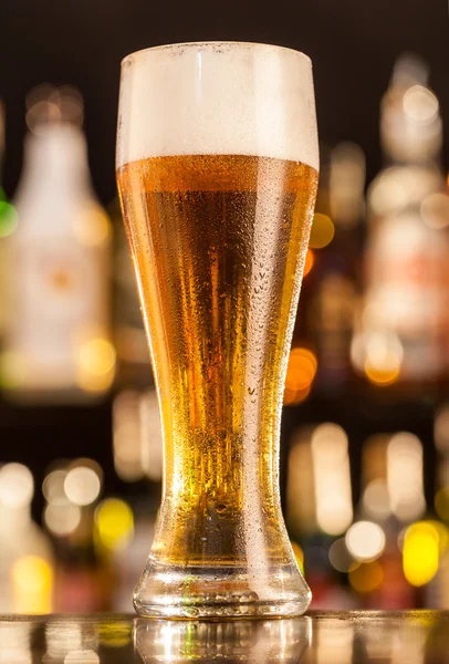 Jug of beer served on bar counter — Stock Photo, Image