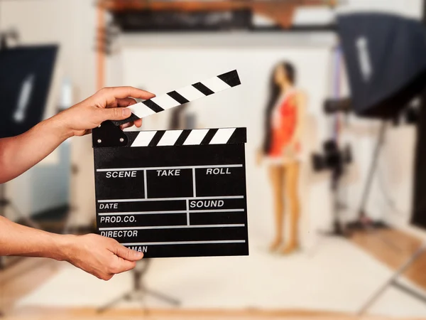 Man with film clapper in studio — Stock Photo, Image