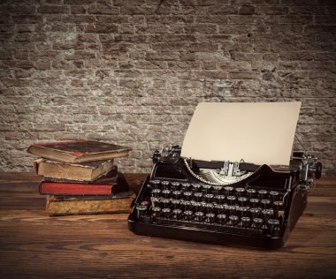 Vintage typewriter on wooden table clipart
