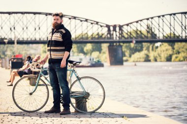 Trendy hipster young man with bycicle
