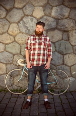 Trendy hipster young man with bycicle