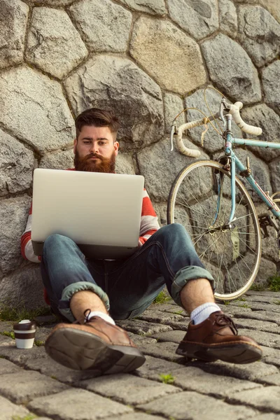 Trendy hipster young man with laptop — Stock fotografie