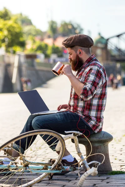 Trendy hipster young man with laptop — Zdjęcie stockowe