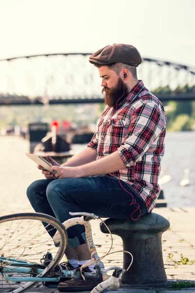 Trendy hipster young man with tablet — Stock Photo, Image