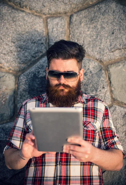 Trendy hipster young man with tablet — 스톡 사진