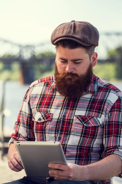Trendy hipster young man with tablet — Stock Photo, Image