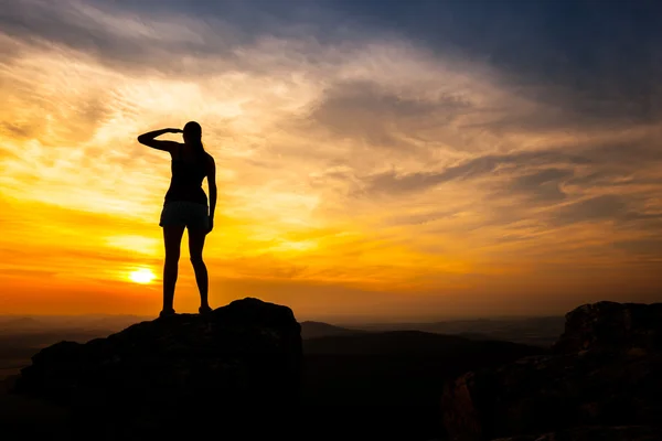 Single adult woman silhouette on rock — Stock Photo, Image