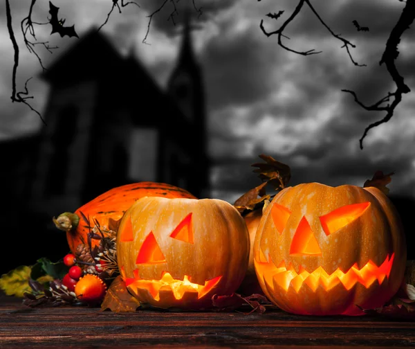 Halloween pompoenen met kerk op achtergrond — Stockfoto