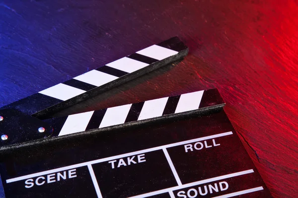 Cinema clapboard on black stone — Stock Photo, Image