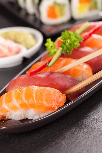 Sushi pieces with chopsticks — Stock Photo, Image