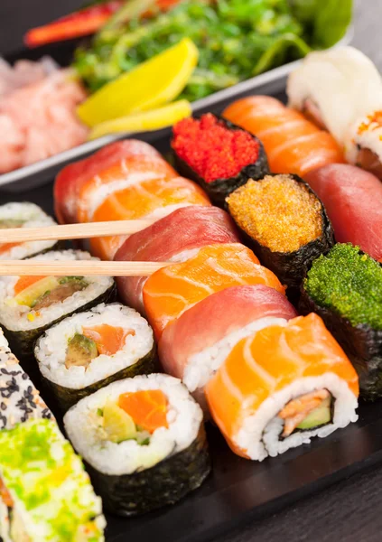 Sushi pieces with chopsticks — Stock Photo, Image