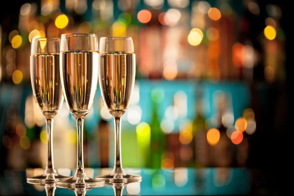 Glasses of champagne on bar counter — Stock Photo, Image
