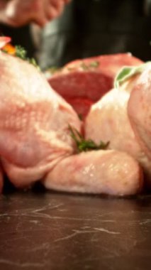 Super Slow Motion of Butcher Hitting the Raw Meat by Cleaver. Filmed on High Speed Cinema Camera.  Meat Preparation Concept, Fire on Background. Camera Placed on Motion Control System. Vertical Aspect Ratio.