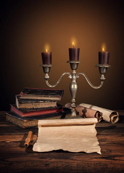 Old vintage books with candles in candlestick Royalty Free Stock Images