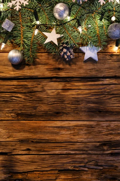 Christmas decoration with fir branches on wooden planks — Stock Photo, Image