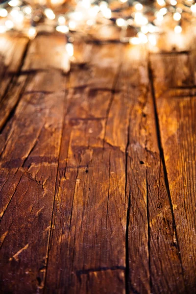 Desenfoque luces de Navidad en tablones de madera — Foto de Stock