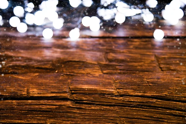 Blur christmas lights on wooden planks — Stock Photo, Image