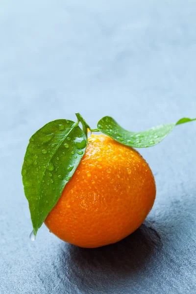 Fresh mandarin on black stone — Stock Photo, Image