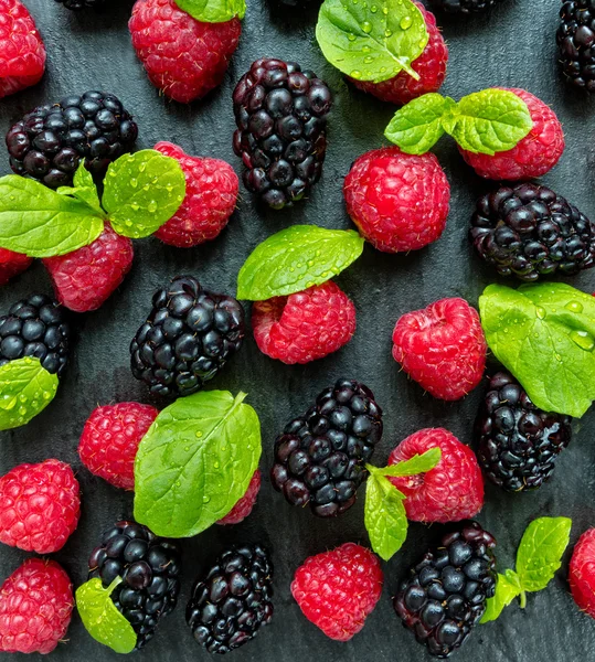 Heap of raspberry and blackberry on stone — Stock Photo, Image