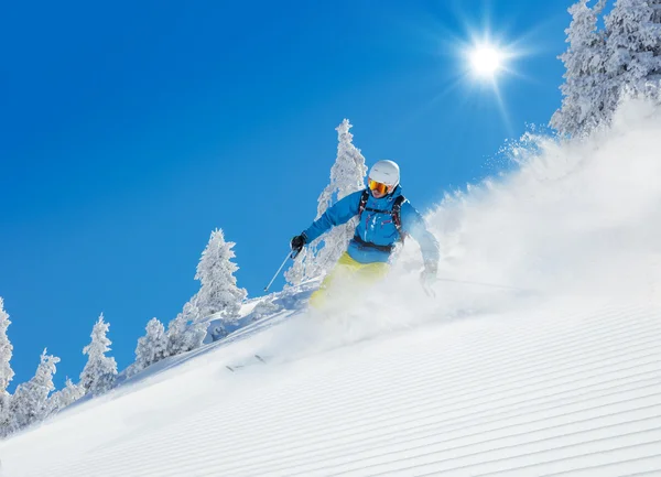 Man skier running downhill Stock Photo