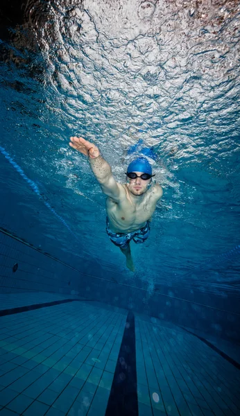 Ung man simmar i poolen — Stockfoto