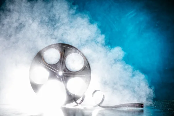 Reel of film with smoke and backlight — Stock Photo, Image