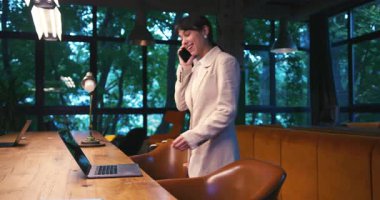 Mutlu, İspanyol iş kadını dizüstü bilgisayarda çalışıyor. Akıllı telefon görüşmesi yapıyor. Motivasyon, Ofiste Başarı. Heyecanlı, Çalışan, Avukat, Kadın İş Kadını İş Kadını.