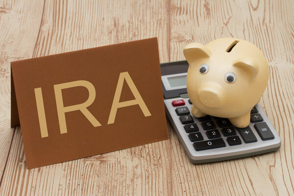 Having a IRA plan, A golden piggy bank, card and calculator on w