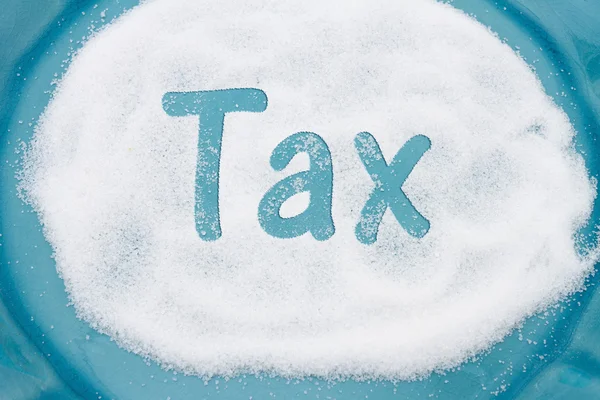 Close-up of Teal Plate with a lot of sugar with text Tax