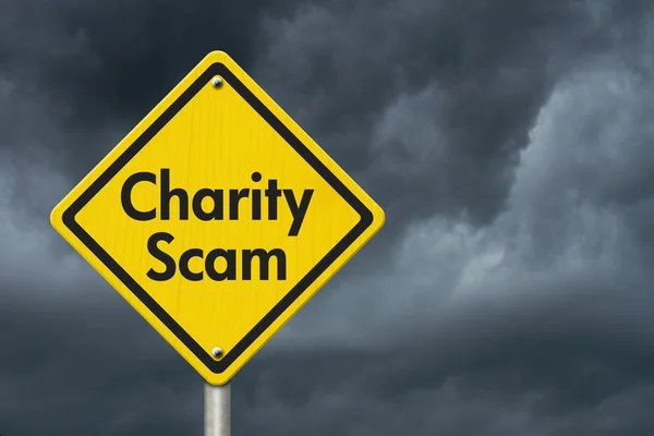 Charity Scam yellow warning highway road sign — Stock Photo, Image