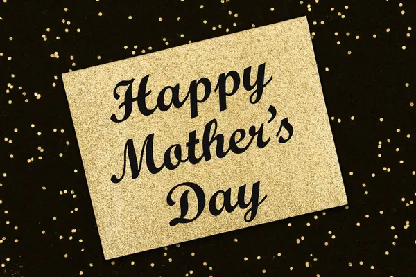 Glückwunschbotschaft Zum Muttertag Auf Goldglitzer Grußkarte Auf Schwarzem Glanz lizenzfreie Stockfotos