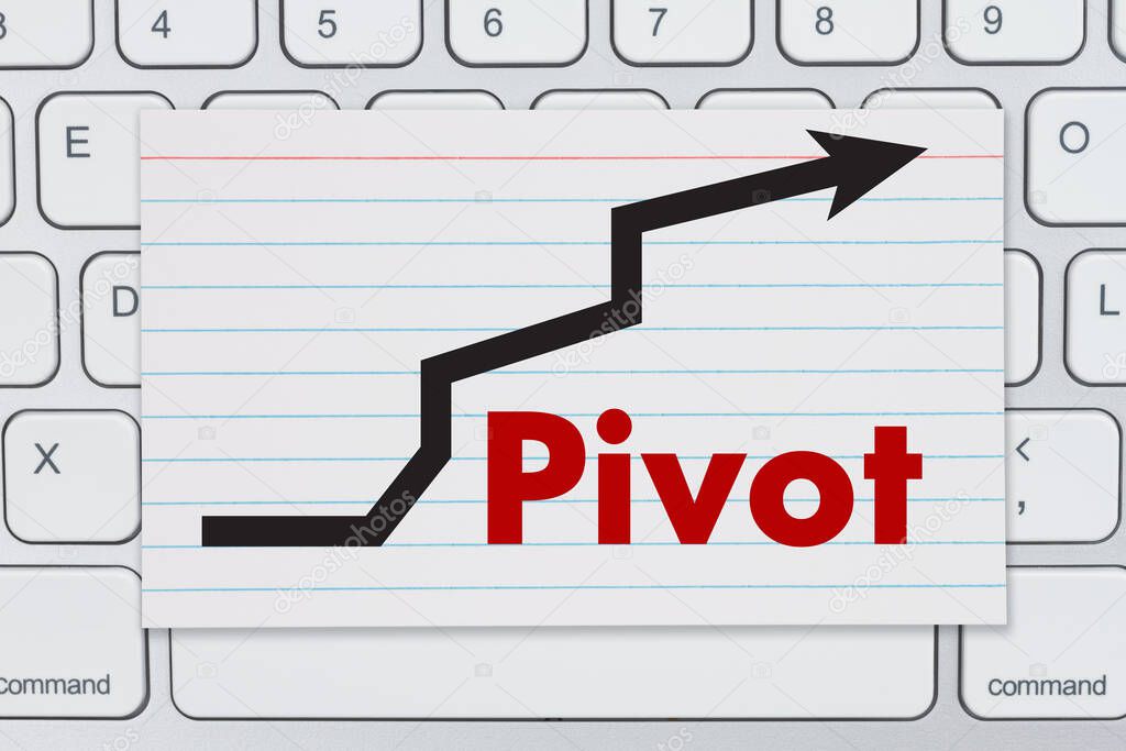 Pivot message with arrow an index card on a gray keyboard 