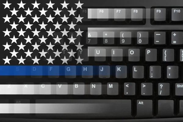 Police on the internet in the US with the United Stated marijuana flag on a black keyboard