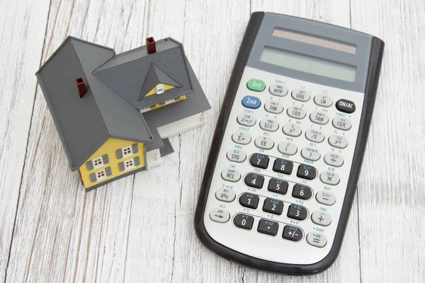 Casa Modelo Com Uma Calculadora Mesa Madeira Para Hipoteca Mensagem — Fotografia de Stock