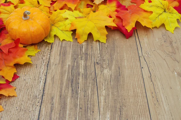 Autumn Leaves and Pumpkin on a Weather Wood Background — Stock Photo, Image