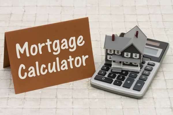 Home Mortgage Calculator, A gray house, brown card and calculato — Stock Photo, Image