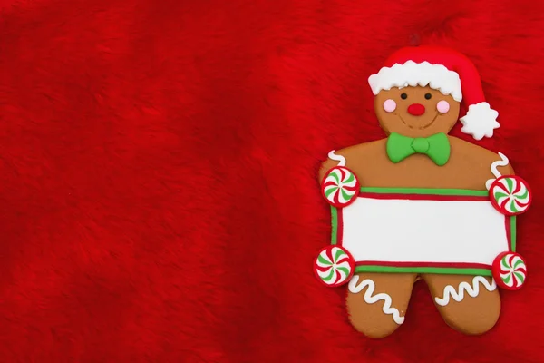 Kırmızı peluş kürk ve zencefilli kurabiye adam Noel arka plan — Stok fotoğraf
